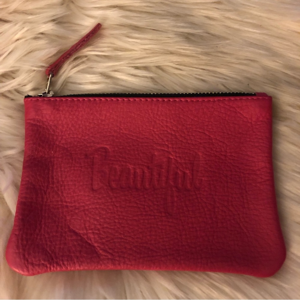 Jesse and Co pink leather zip pouch with Beautiful embossed on front raw lining